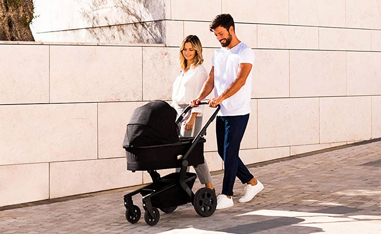 parents walking with bassinet stroller